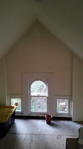 Before shot of the attic!  Notice the plywood floor, no lighting and the off white walls and ceiling.